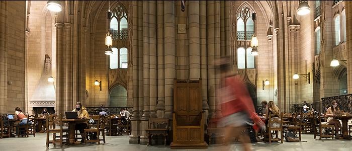 students studying under the stone archways of the Commons Room of Cathedral of Learning