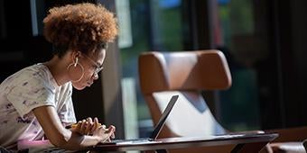 student studying between classes on Pitt-Johnstown campus